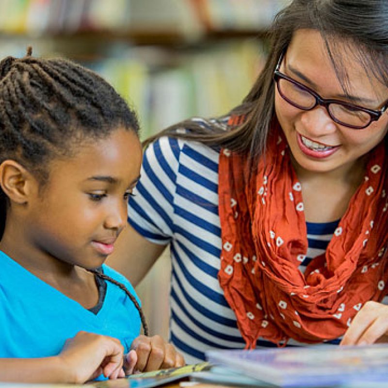 RISE Women teaching a young girl