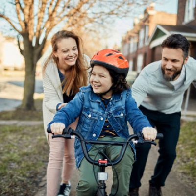 foster-family-2-parents-and-child-riding-a-bike Foster family with child riding a bike
